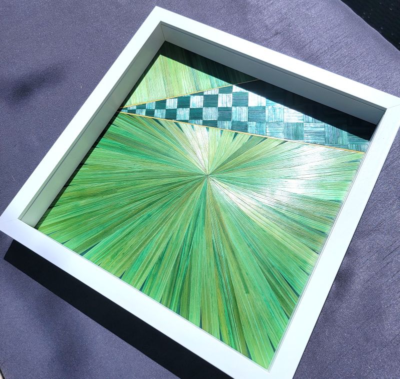 Marquetry - A green bolt of lightning above the green sun.